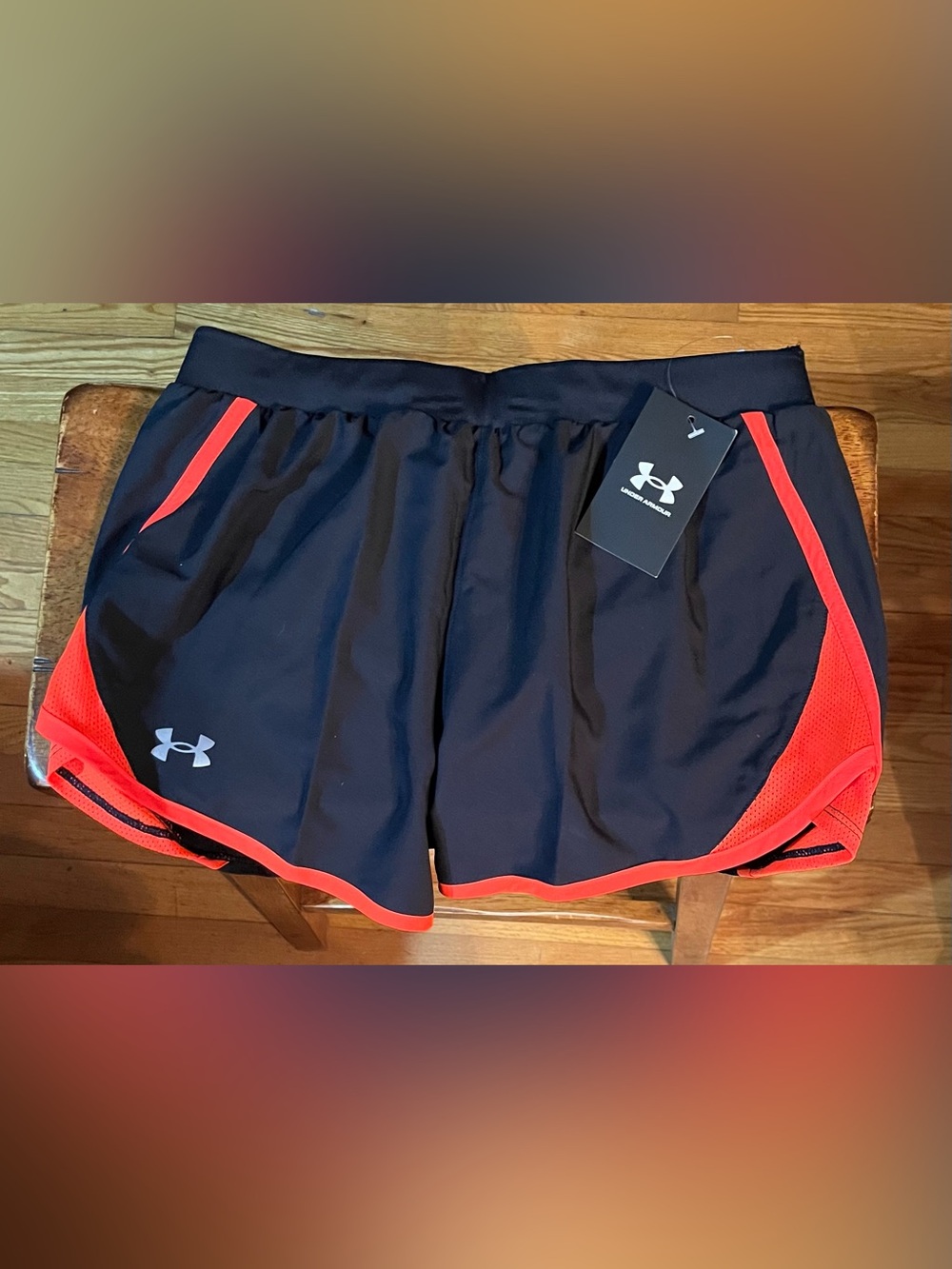 UNDER ARMOUR - Women’s Black Athletic Shorts with coral/salmonTrim.